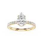 Gold ring with a pear-shaped diamond and smaller diamonds on a white background