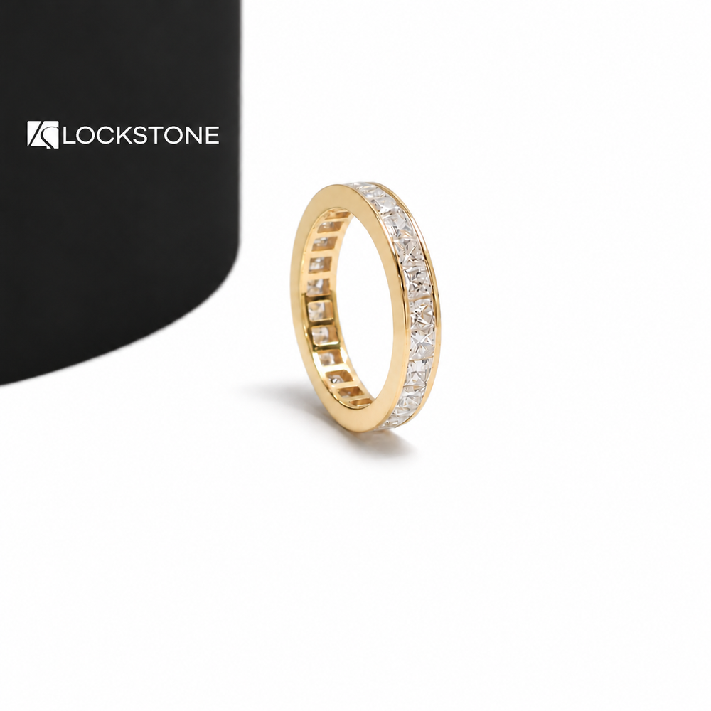 A full eternity ring in yellow gold with princess shaped diamonds secured between smooth polished metal edges