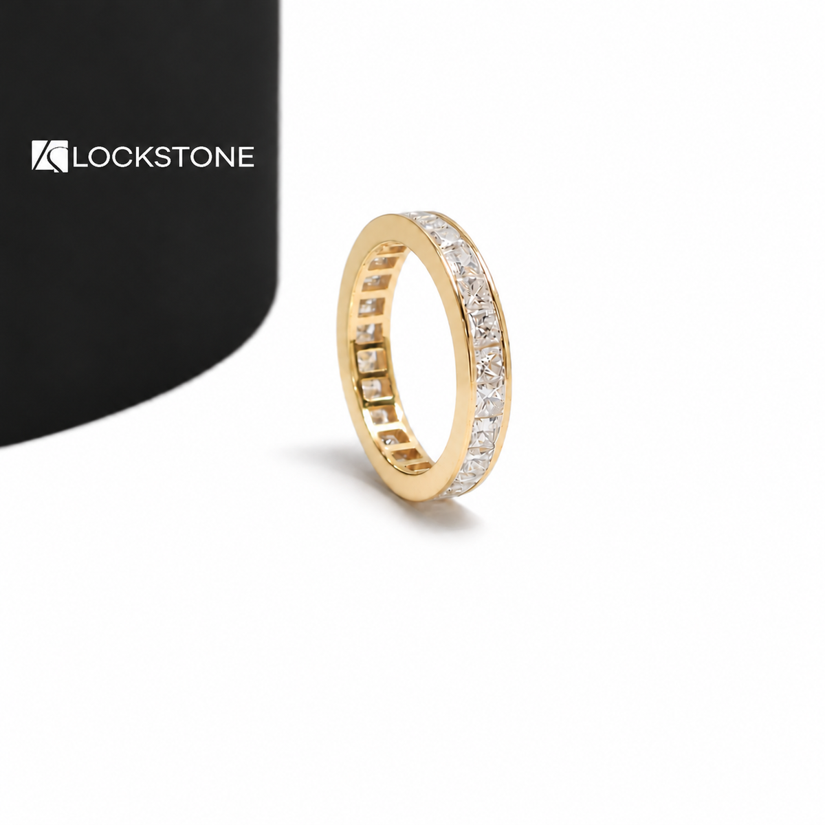 A full eternity ring in yellow gold with princess shaped diamonds secured between smooth polished metal edges