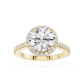 Gold ring with a large diamond and smaller diamonds on the band against a white background