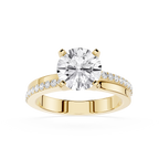 Gold ring with a large diamond and smaller diamonds on the band against a white background