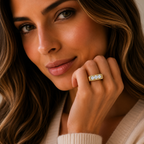 Woman wearing a gold ring with a diamond, close-up of face and hand.