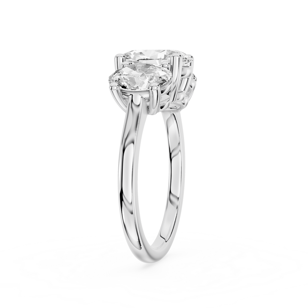 A trio of prong set oval cut diamonds forms this white gold engagement ring with a smooth rounded band