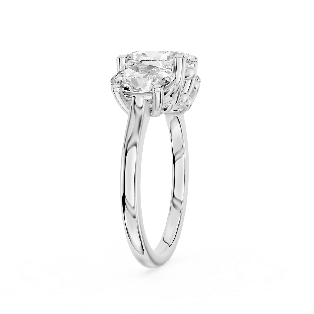 A trio of prong set oval cut diamonds forms this white gold engagement ring with a smooth rounded band