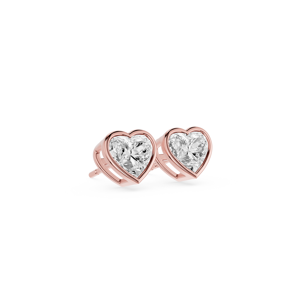 Heart-shaped diamond earrings with rose gold setting on a white background